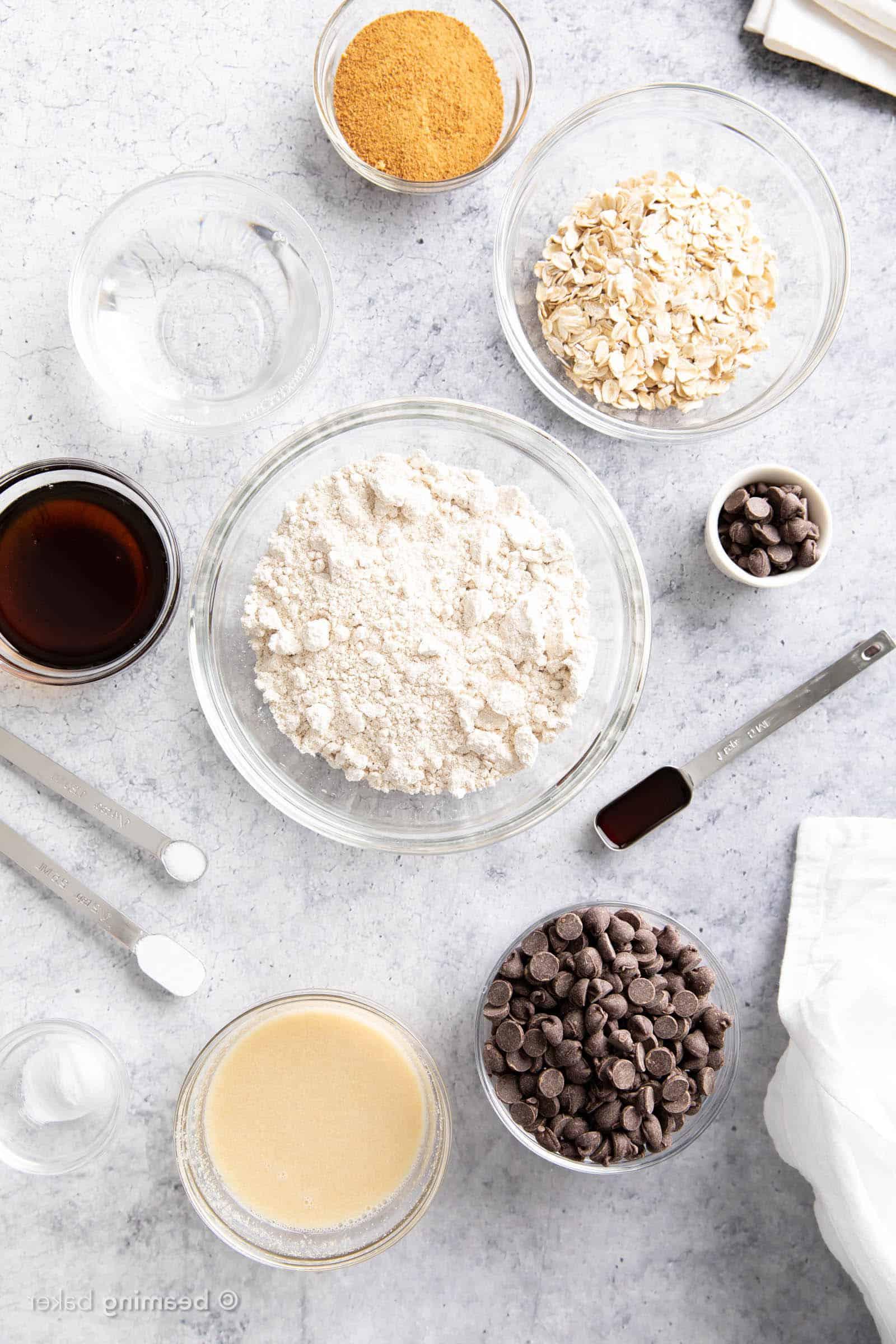 Oat flour cookies ingredients in mis en place on kitchen counter including oat flour and chocolate chips