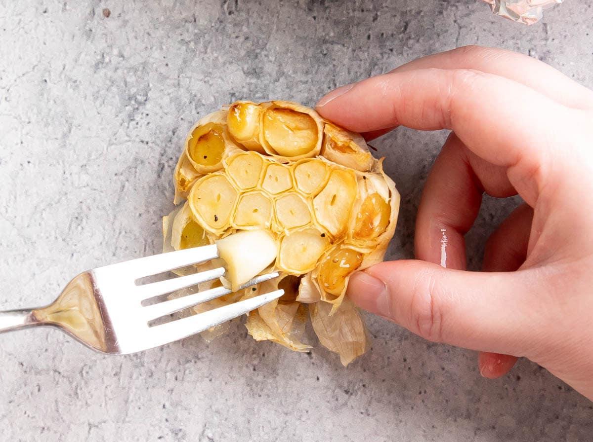 Geröstetes Knoblauchbrot {Hausgemachtes Rezept} 7 Zwei Fotos, die zeigen, wie man geröstetes Knoblauchbrot zubereitet – die Knoblauchzehen entfernen
