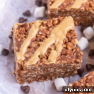 Ultimate Chocolate Peanut Butter Krispie Bars 2 Close up of a chocolate peanut butter rice krispie treat with peanut butter drizzle on top.