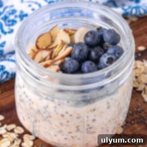 vanilla overnight oats in a 12 ounce Mason jar topped with blueberries and sliced almonds.