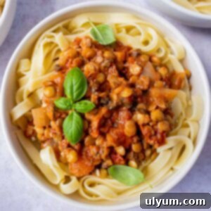 A delicious bowl of vegan mushroom lentil bolognese served with pasta.