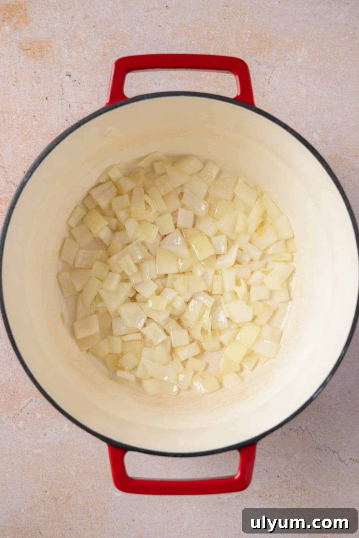 Sautéing diced onion in a large pot.