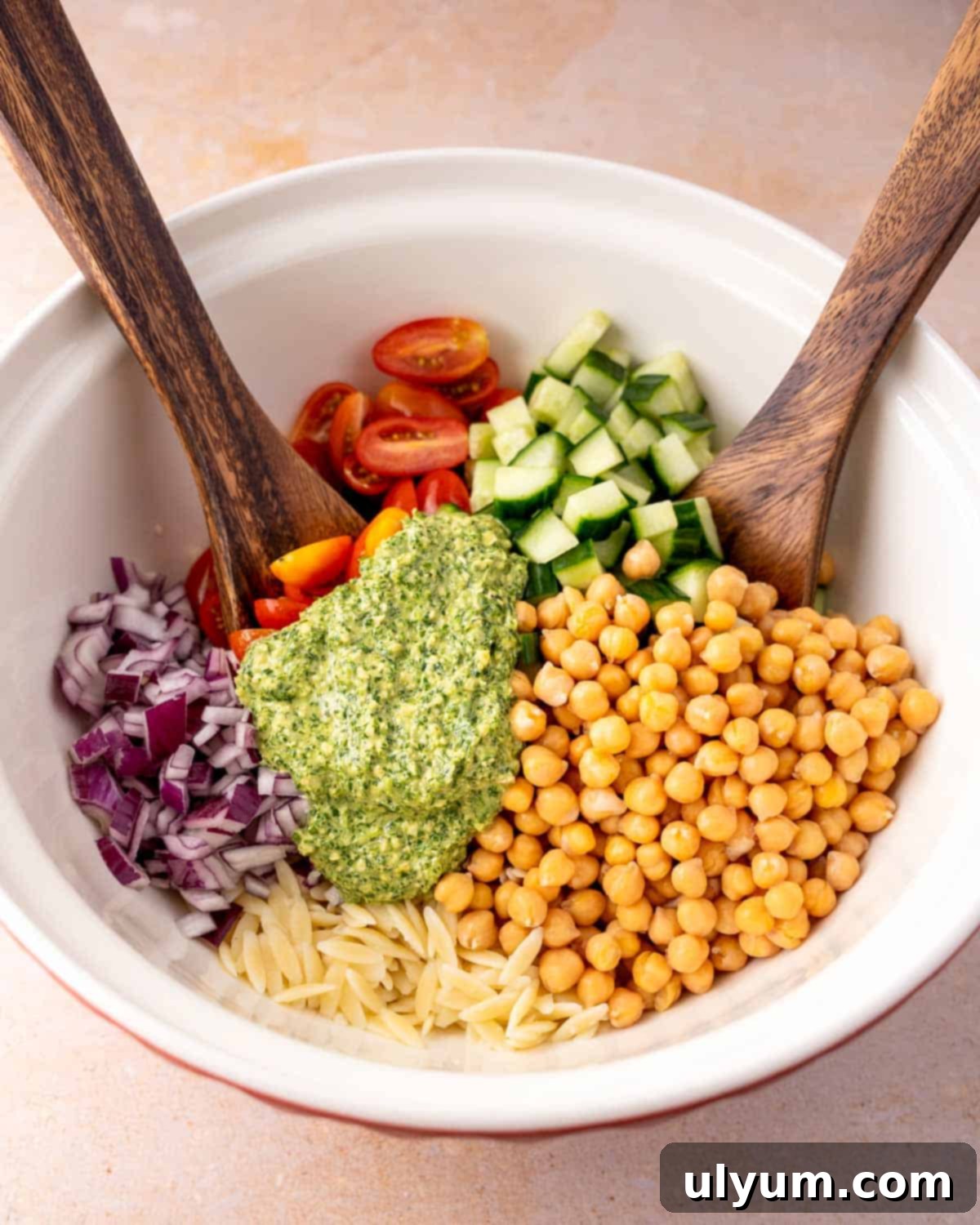 Pesto Orzo Salad ingredients in mixing bowl.