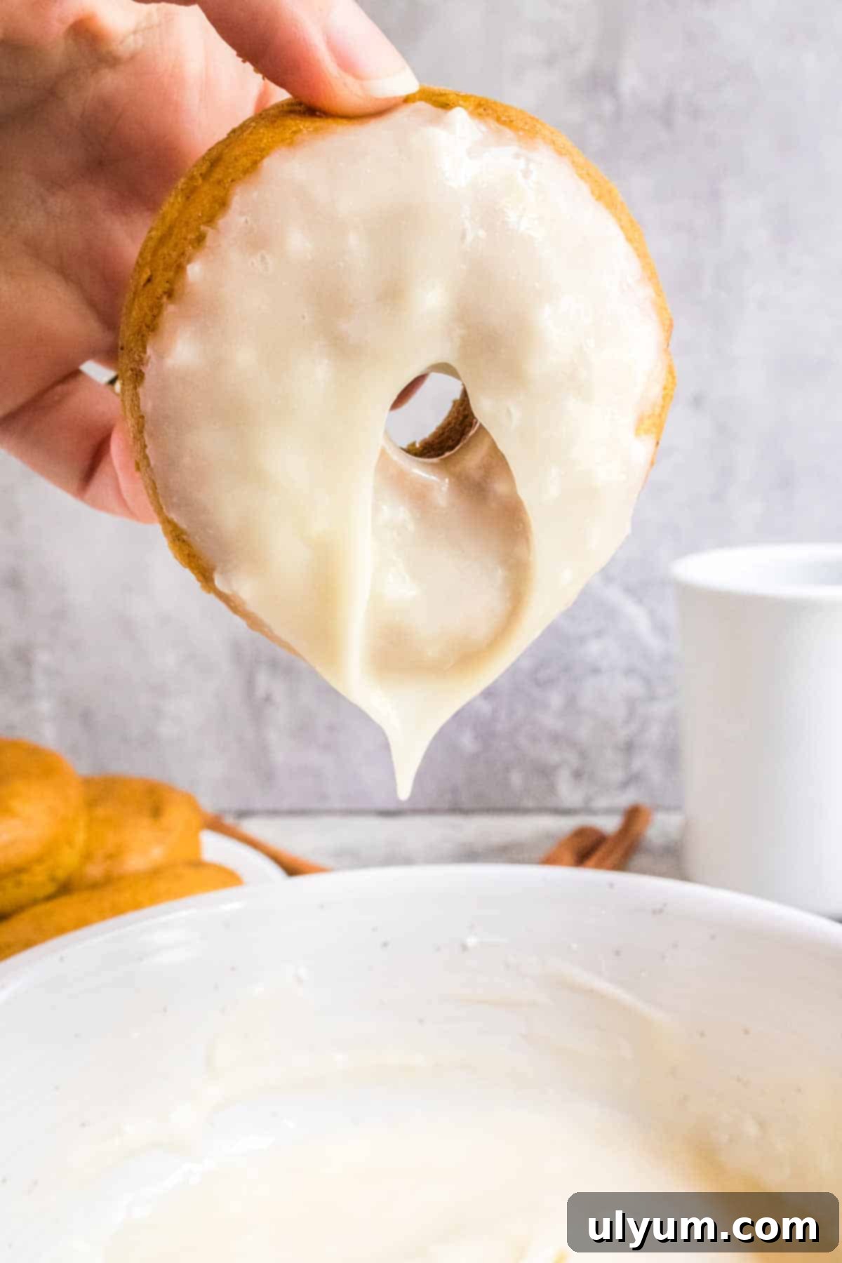 Spiced Baked Pumpkin Donuts with Velvety Cream Cheese Frosting 11 Donut dipped by hand in glaze.