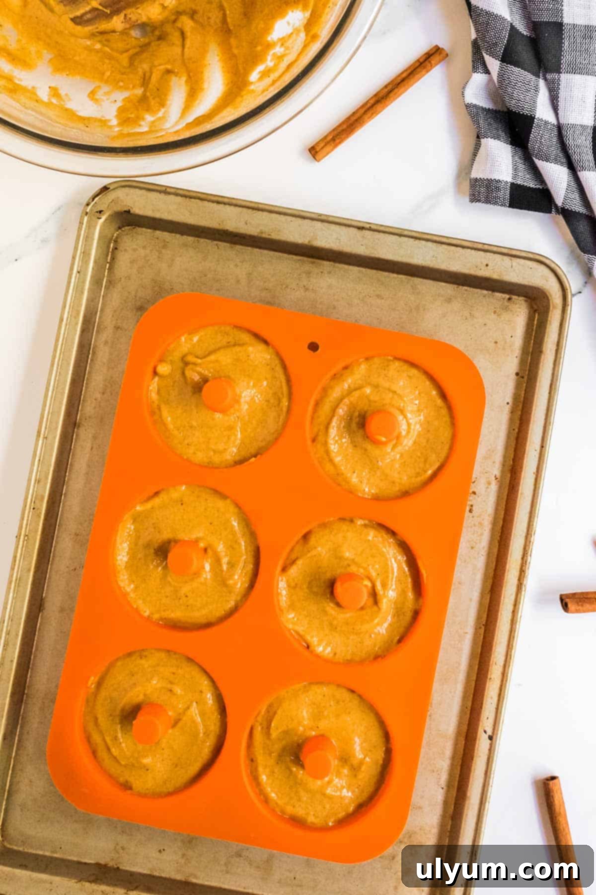 Spiced Baked Pumpkin Donuts with Velvety Cream Cheese Frosting 8 Donut batter in silicone donut pan.