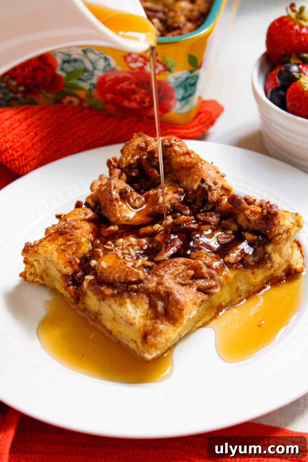 Maple syrup poured over French toast casserole slice.