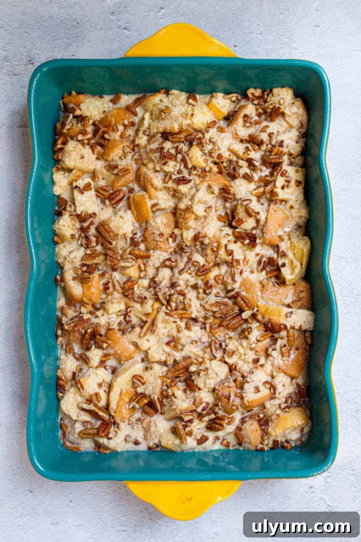 Chopped pecans sprinkled evenly over French toast casserole.