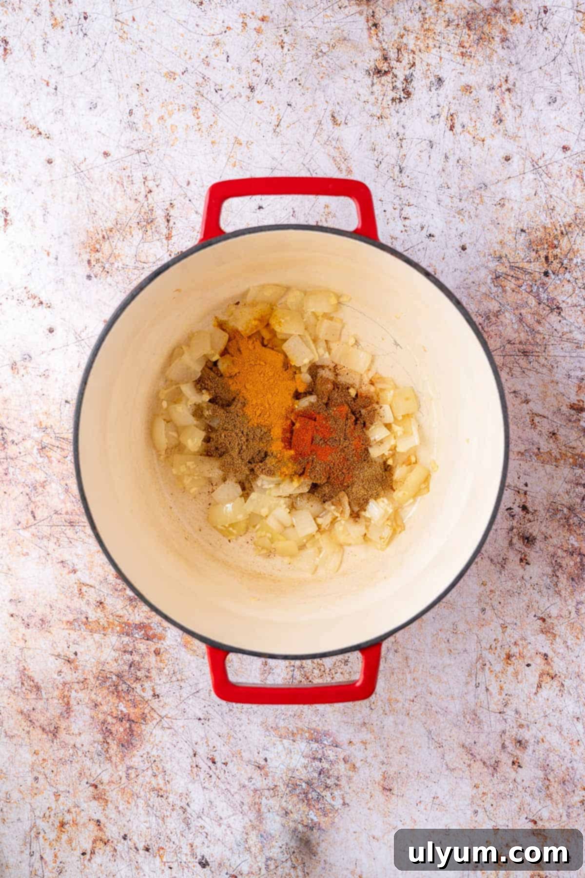 Vibrant Coconut Chickpea & Spinach Curry 6 A colorful blend of Indian spices added to the onion mixture in a pot, cooking until fragrant.