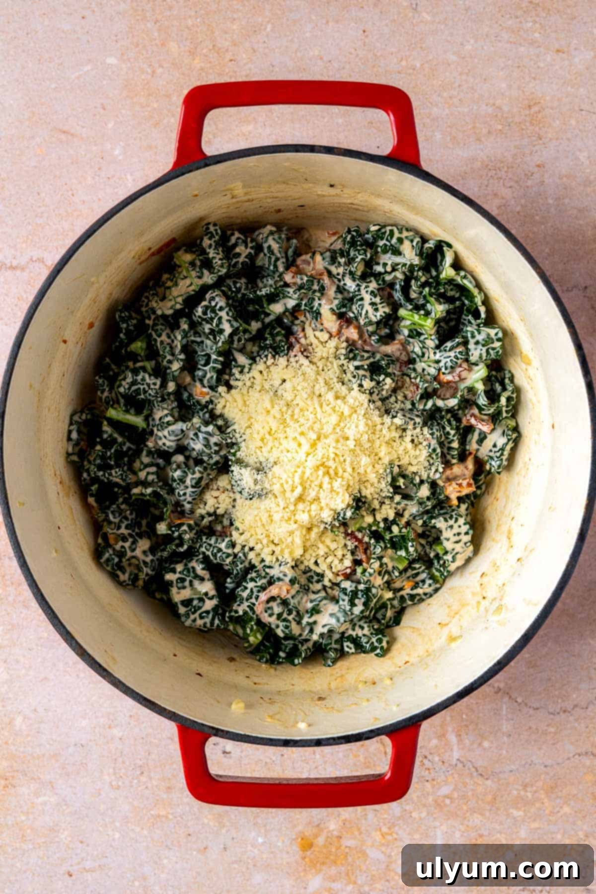 Parmaesan cheese added to cooked kale.
