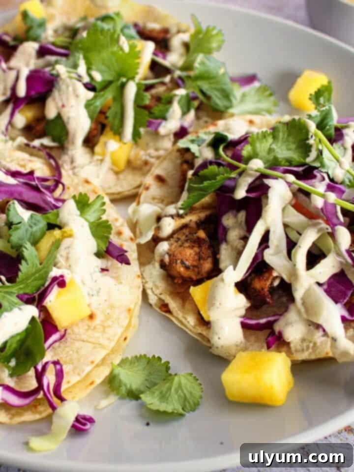 Spicy, sweet, and tangy Jerk Chicken Tacos with pineapple and lime