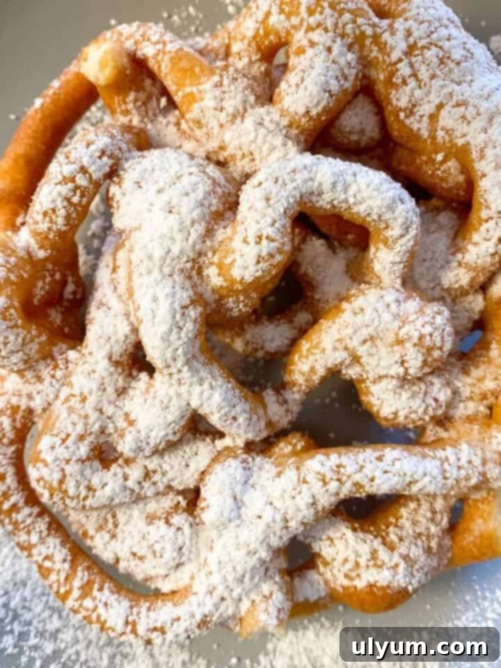 Easy Homemade Fried Funnel Cake with powdered sugar