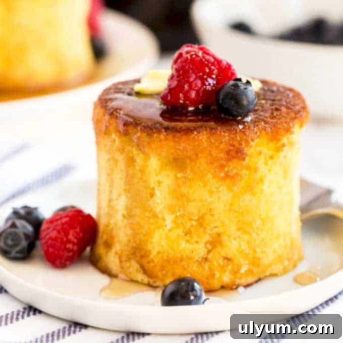 A stack of incredibly fluffy Japanese pancakes drizzled with syrup.