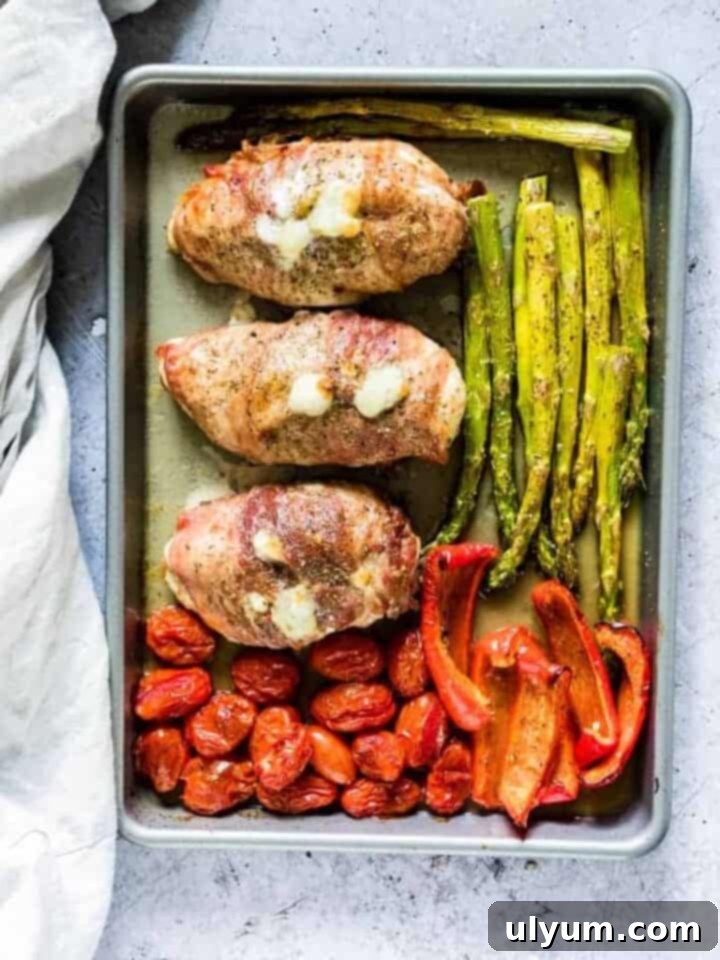 41 Easy Sheet Pan Dinner Ideas 20 Prosciutto Wrapped Chicken Dinner with Asparagus, Bell Peppers, and Cherry Tomatoes