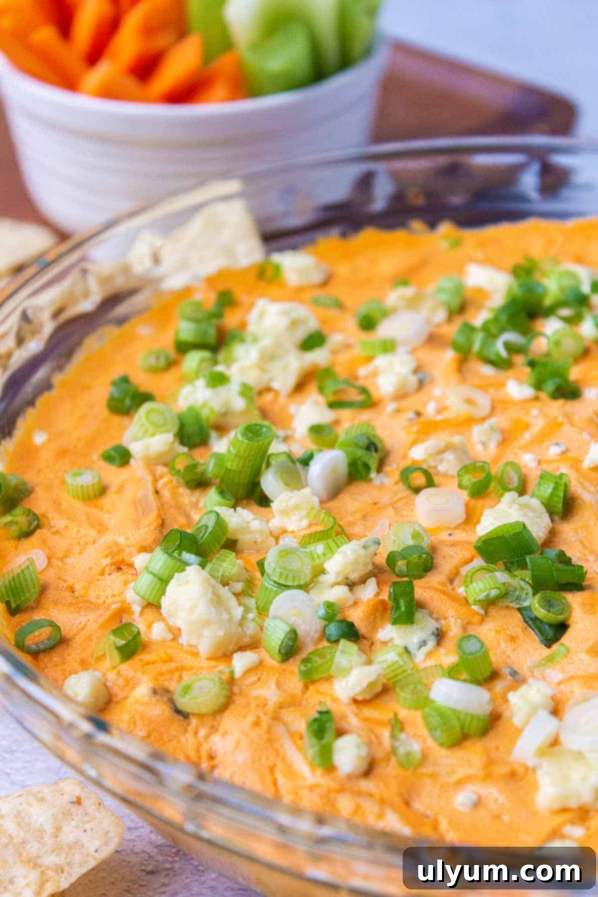 Lightened Buffalo Chicken Dip with Cottage Cheese 2 Healthy Buffalo Chicken Dip, garnished with blue cheese and green onions, ready to serve.
