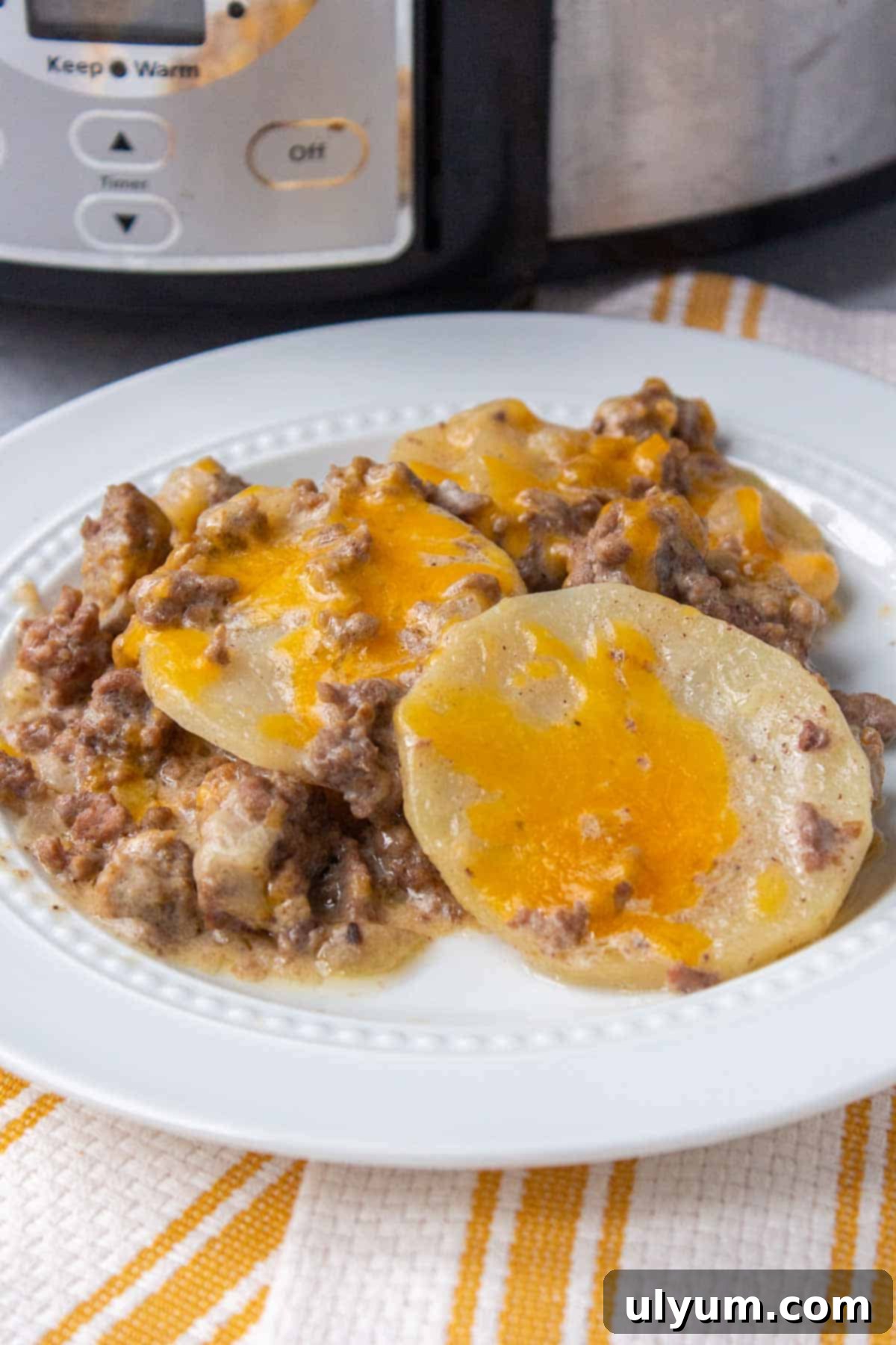 Crockpot Hamburger Potato Casserole, a hearty dish with ground beef, potatoes, and melted cheese, garnished with fresh parsley.