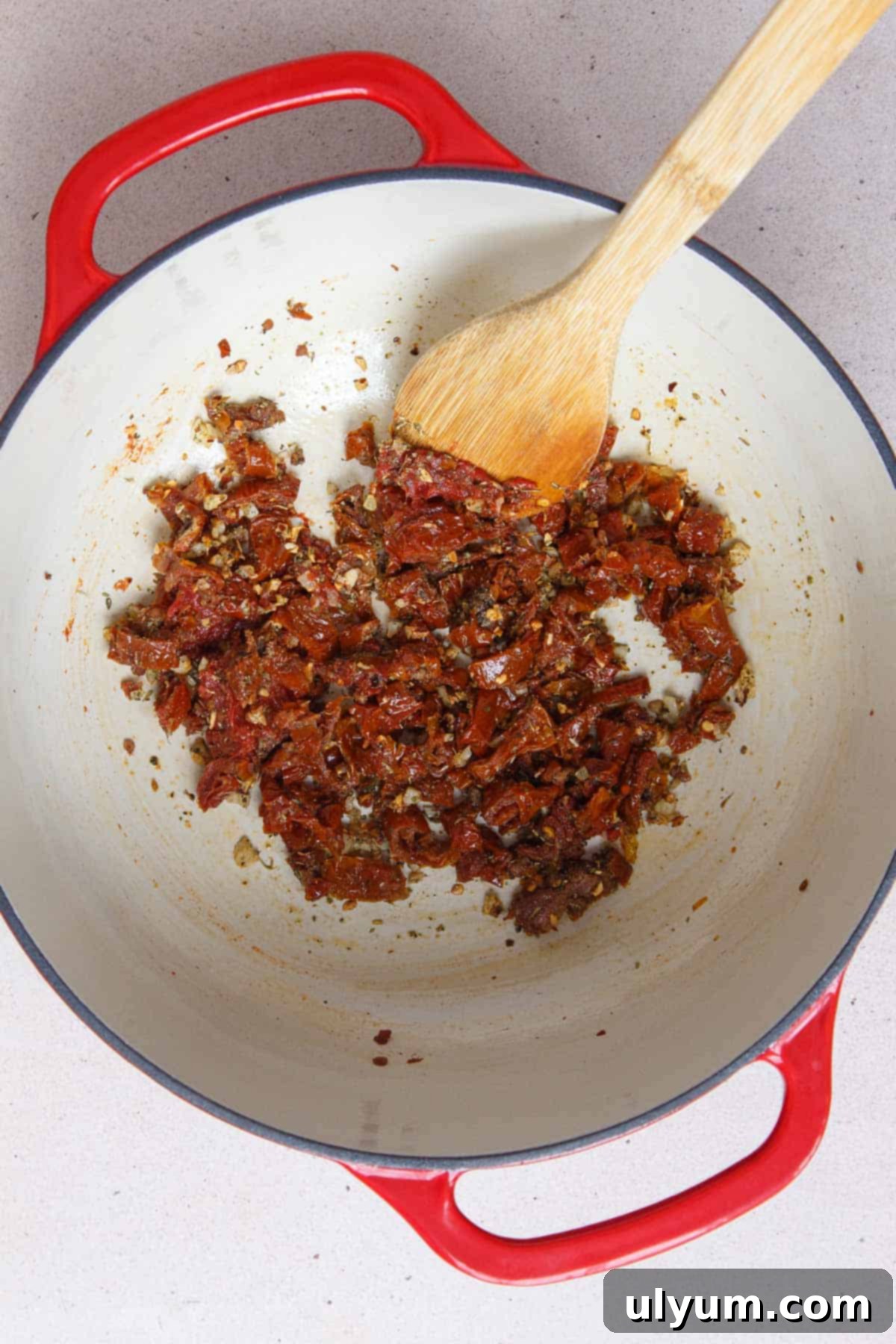 Effortless One-Pot Sun-Dried Tomato Pasta 5 Stirring in sun-dried tomatoes, tomato paste, Italian seasoning, garlic powder, and black pepper into the pot