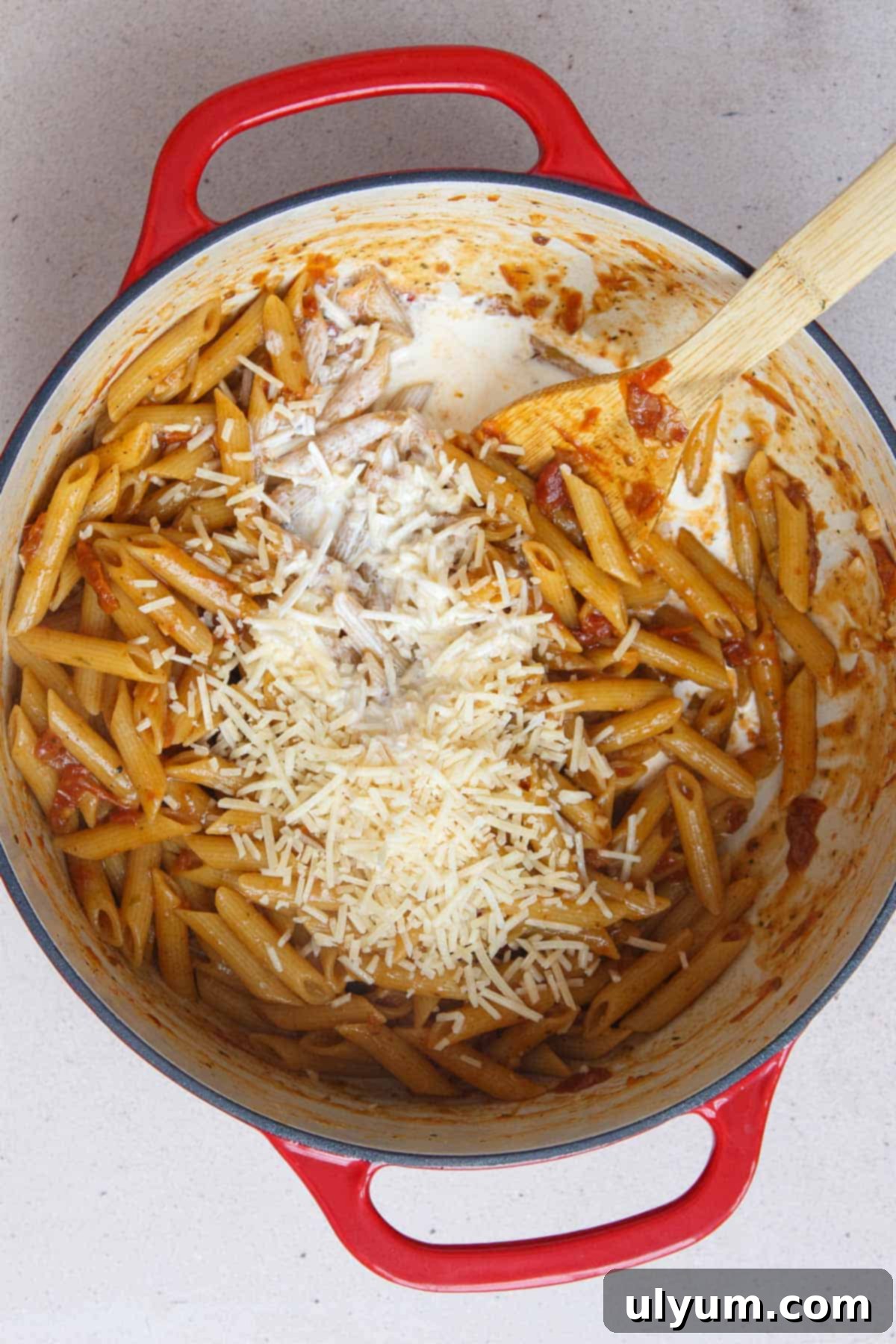 Effortless One-Pot Sun-Dried Tomato Pasta 9 Adding Parmesan and heavy cream to the cooked penne mixture for a creamy finish
