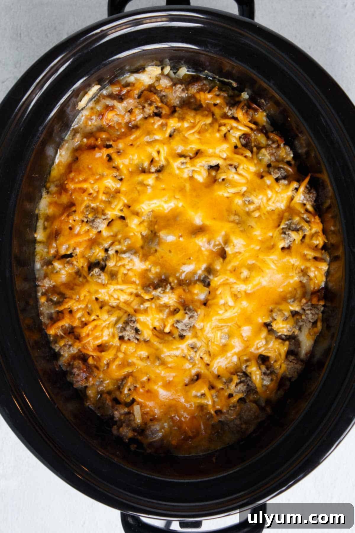 Cheese melted over Crockpot Hamburger Hashbrown Casserole