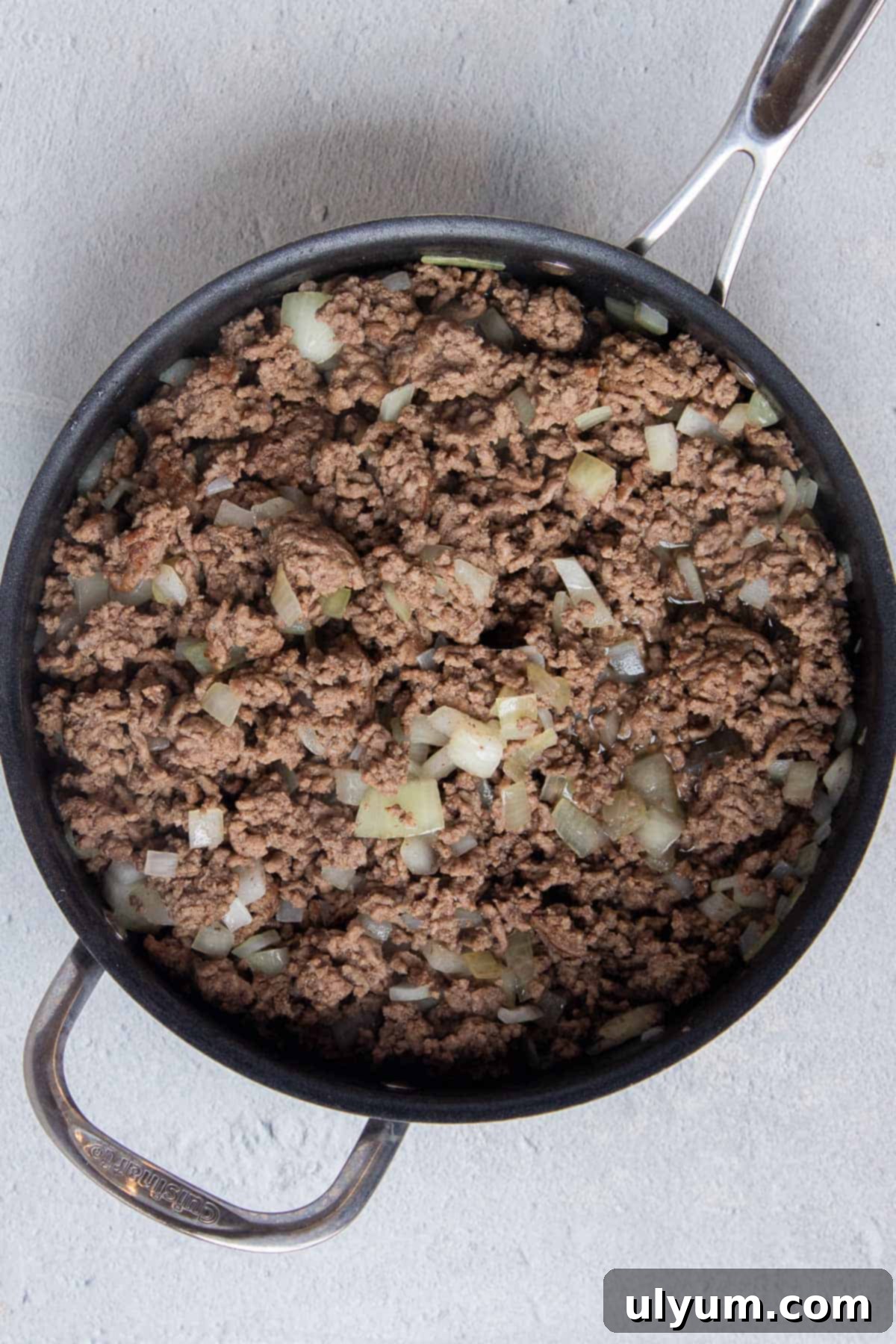 Browned ground beef and cooked diced onion in a large skillet