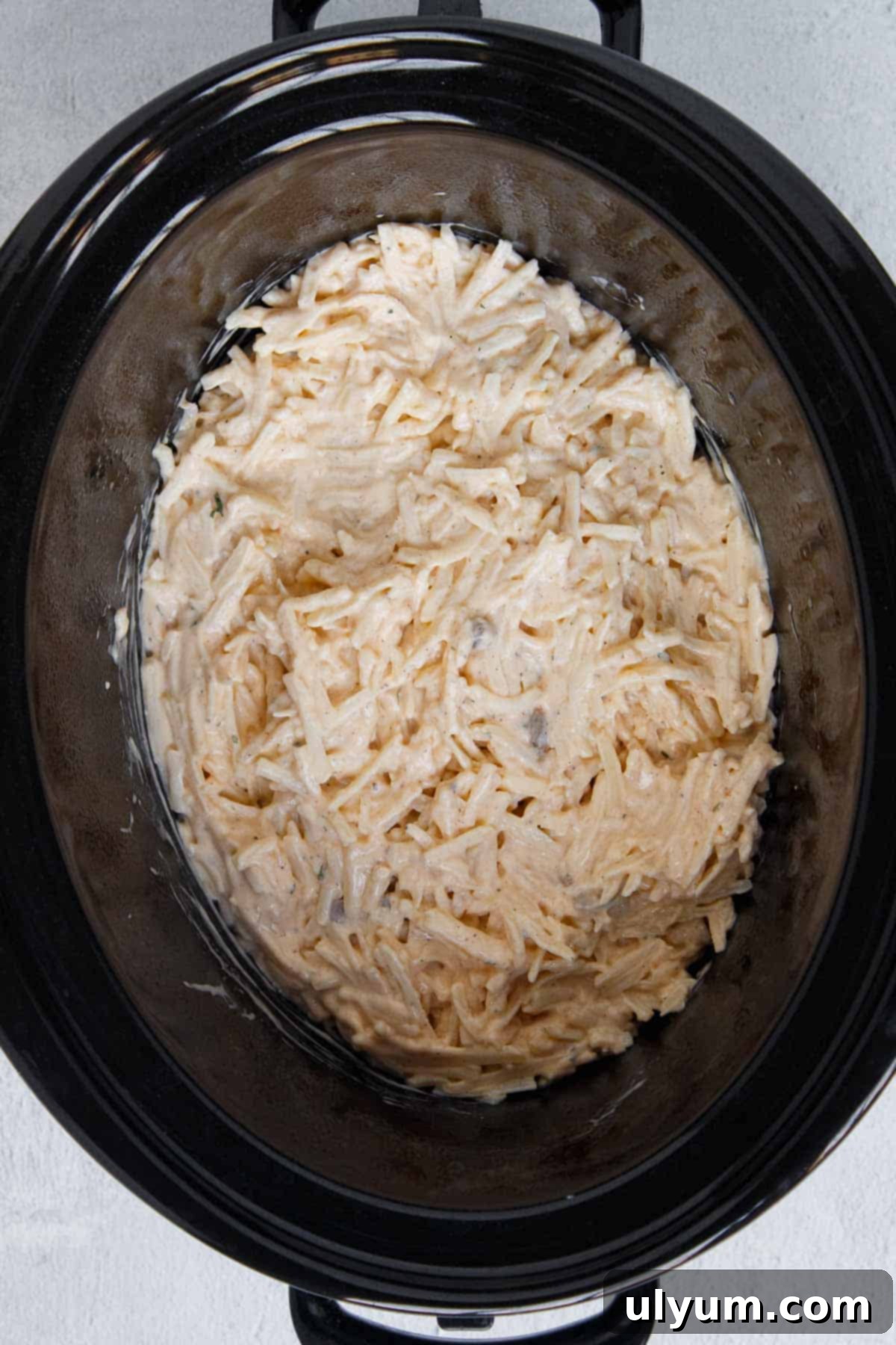 Crockpot Hamburger Hashbrown Casserole layer of shredded potatoes