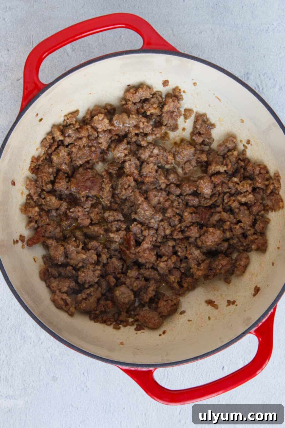 Creamy One-Pot Italian Sausage Pasta 5 Browned Italian sausage cooking in a large pot, showing texture.