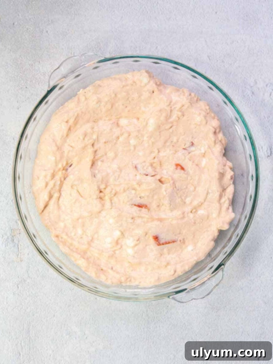 Cream cheese mixture spread in a 9-inch glass pie dish.