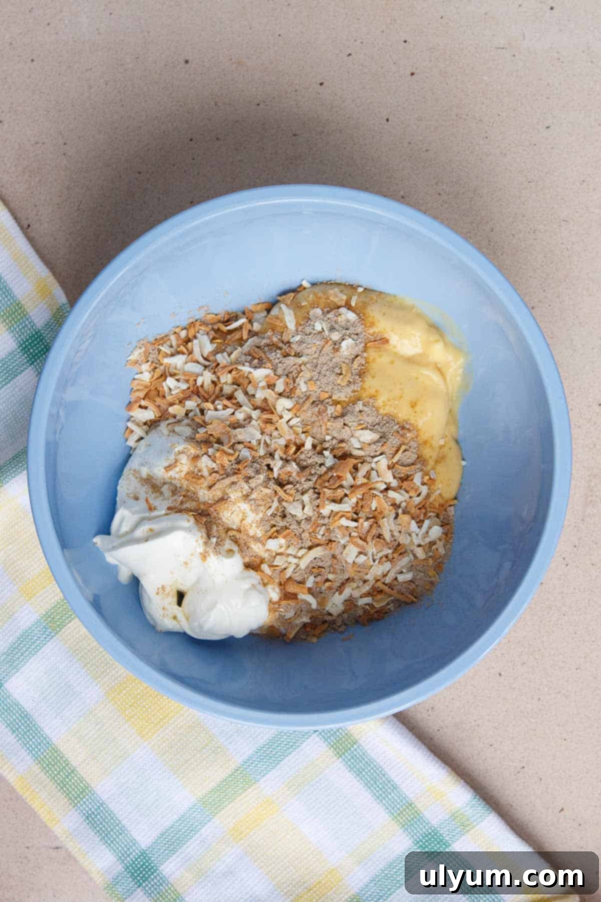 Sour cream, dry onion soup mix, and cream of chicken soup in a mixing bowl