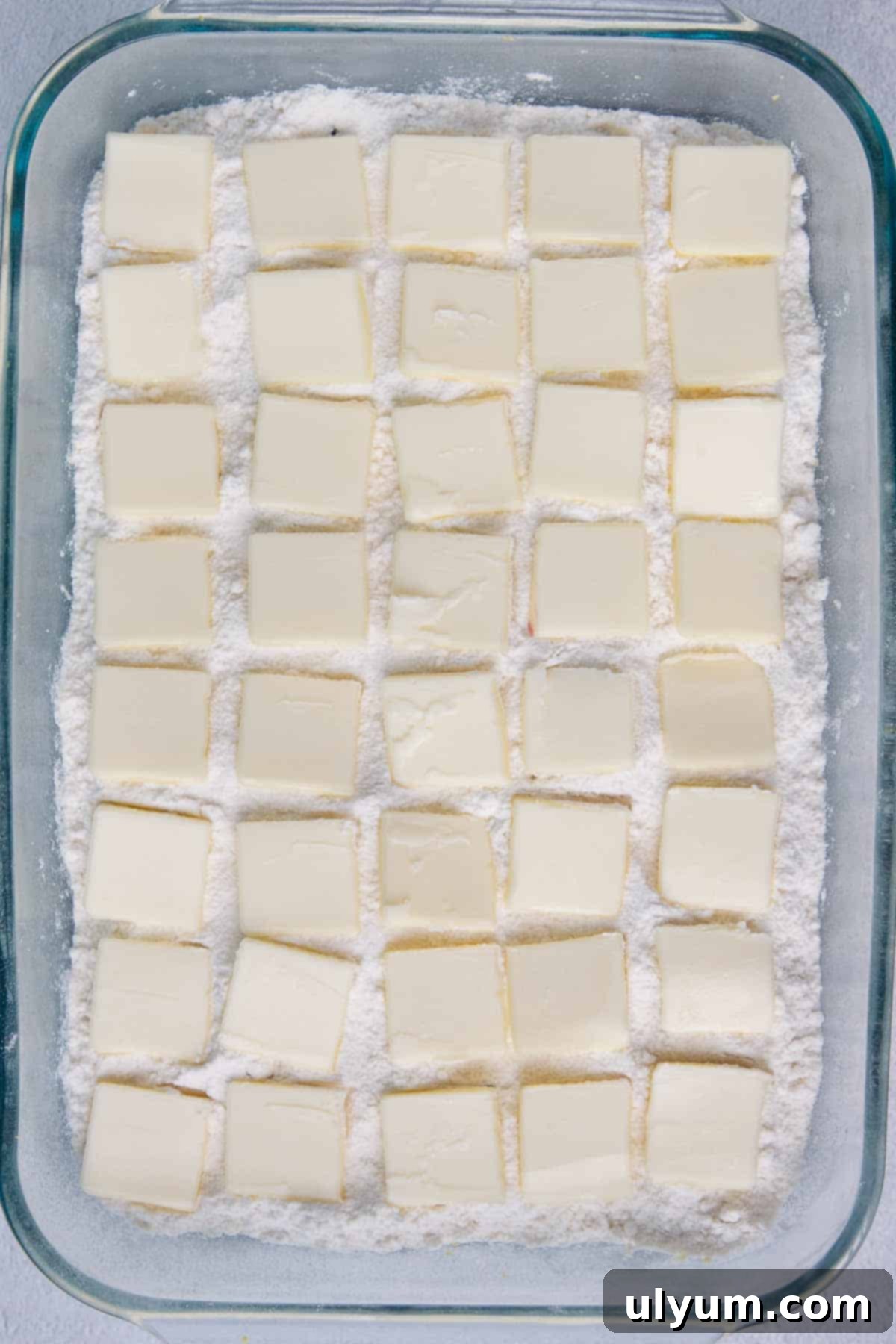 Thin butter slices distributed evenly on top of cake mix