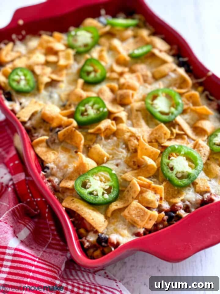 15 Hearty Homestyle Hamburger Casserole Recipes 6 Frito Pie Casserole in a red baking dish with corn chips