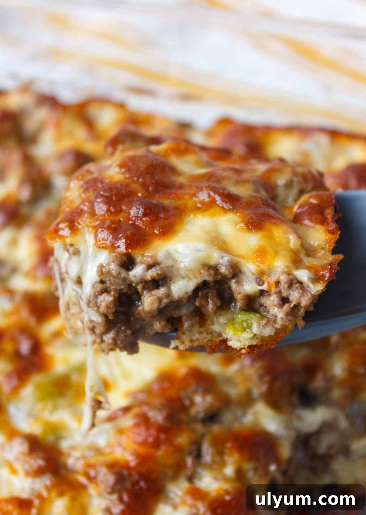 Philly cheesesteak casserole, a hearty and easy dinner with ground beef, onions, peppers, and cheese, served hot from the dish.