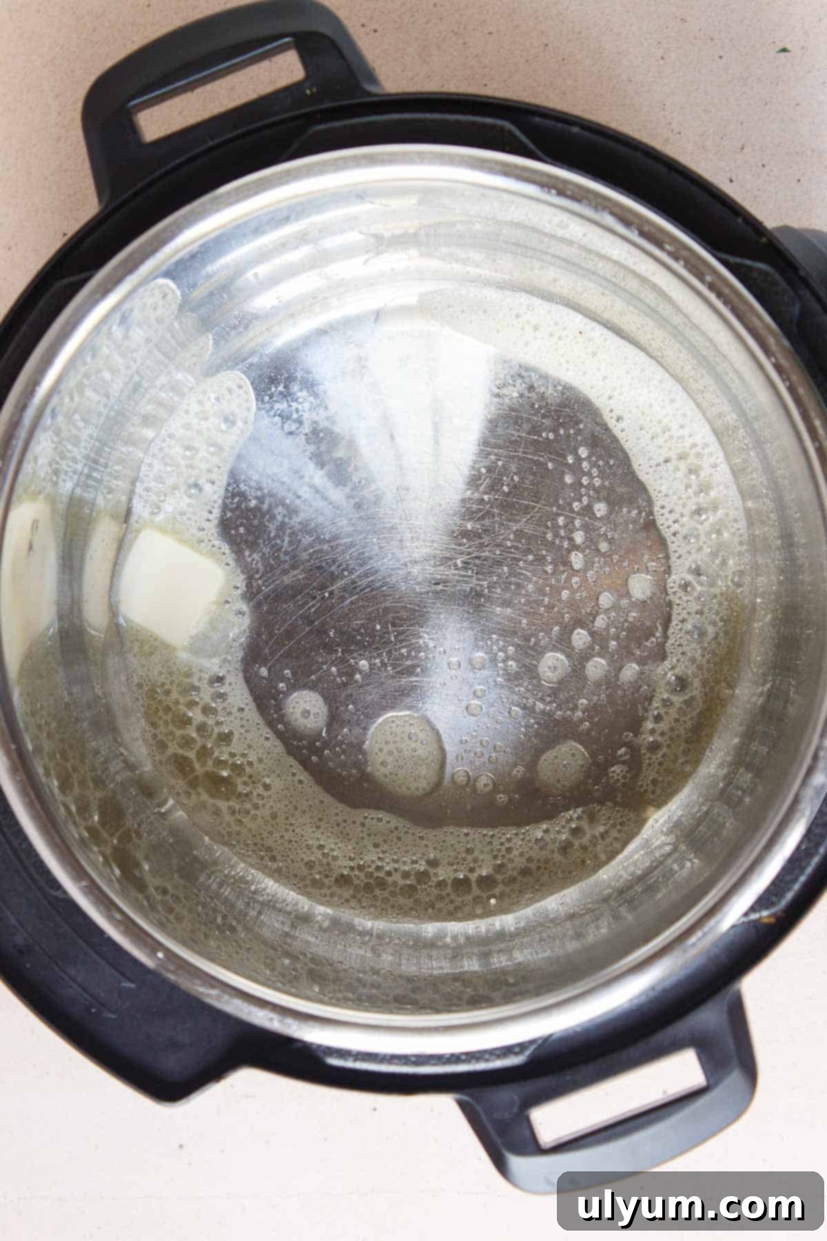 Butter melting in an Instant Pot for the chicken stuffing casserole