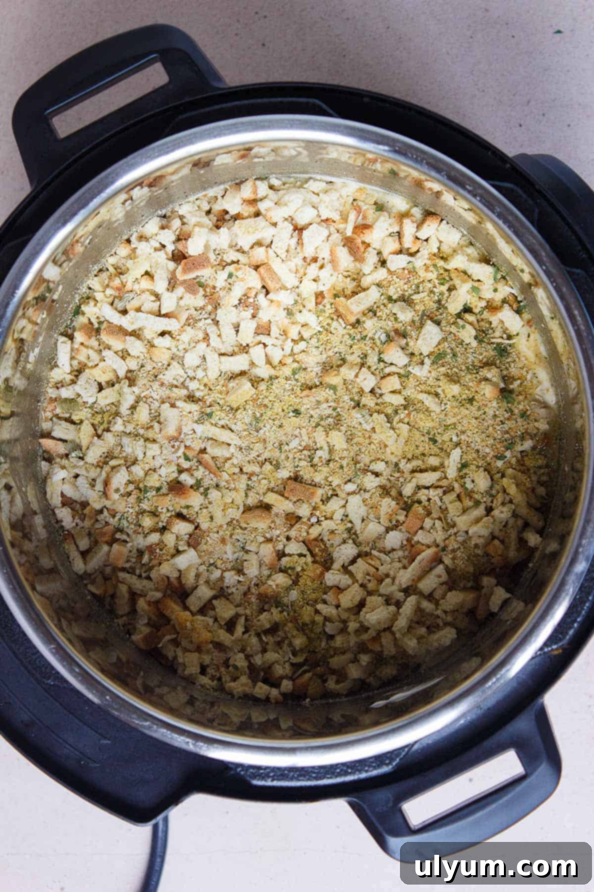 Dry Stove Top stuffing sprinkled evenly over the top of the soup layer in the Instant Pot