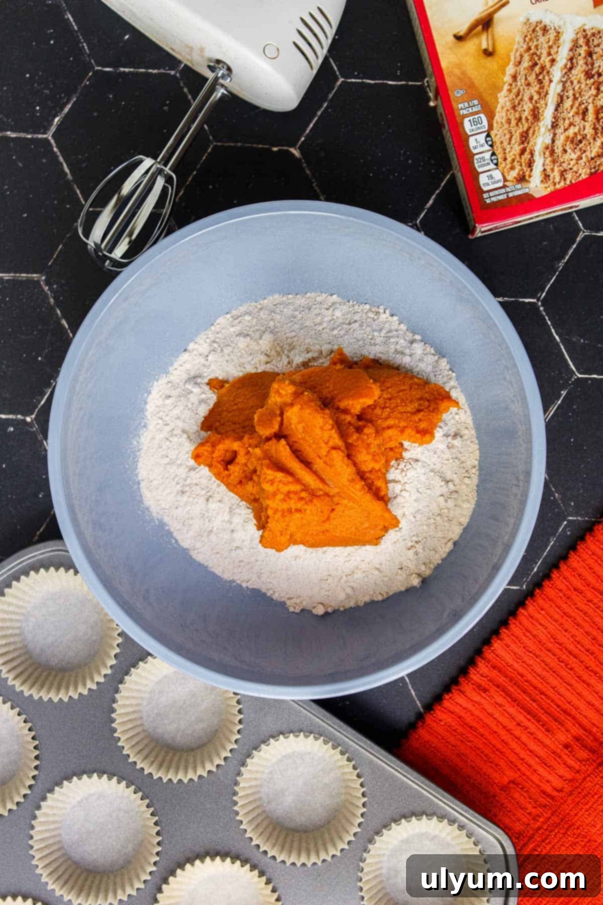 Spice cake mix and pumpkin puree in a mixing bowl