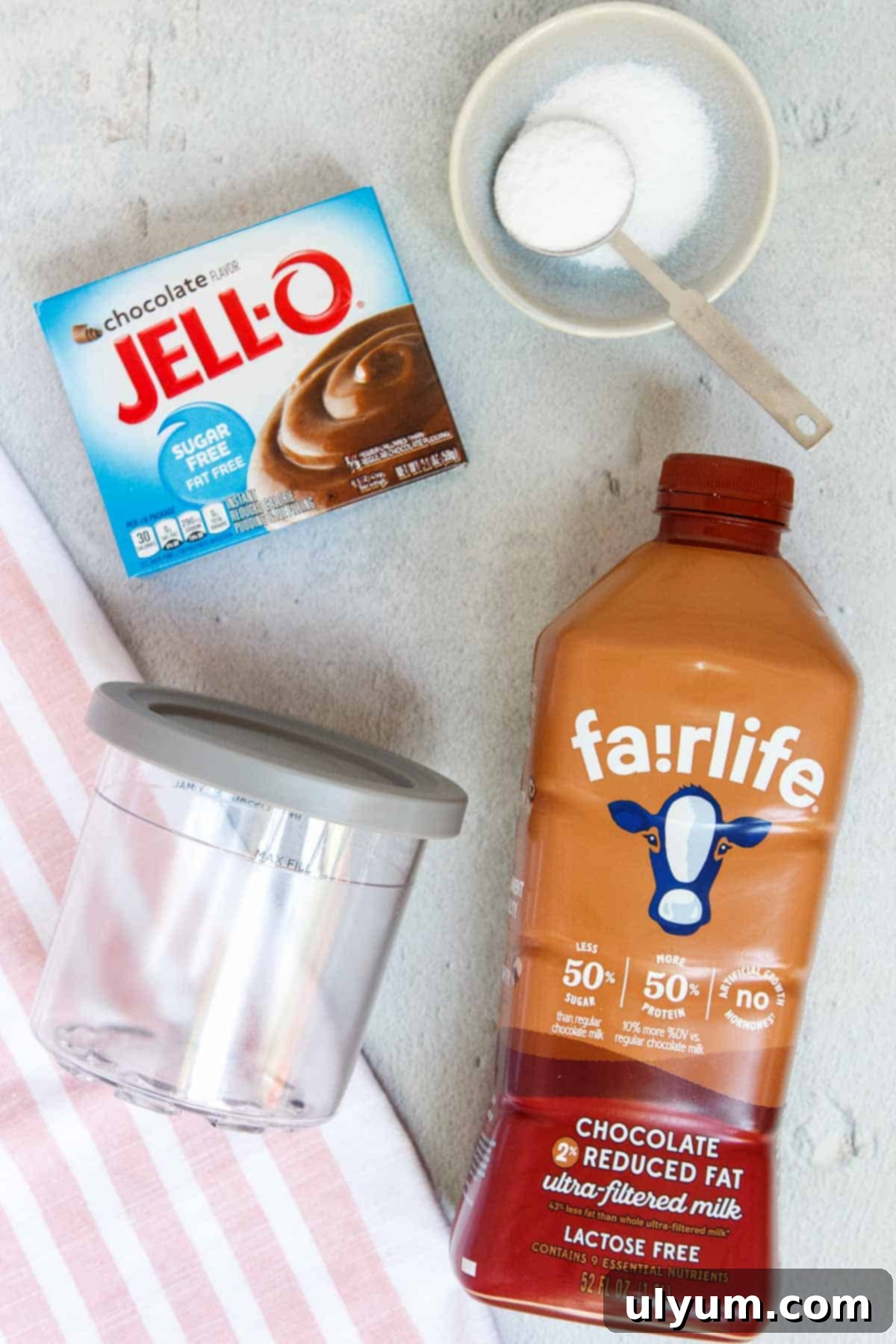 Ninja Creami Chocolate Protein Ice Cream ingredients laid out: Fairlife chocolate milk, Stevia, and sugar-free chocolate pudding mix