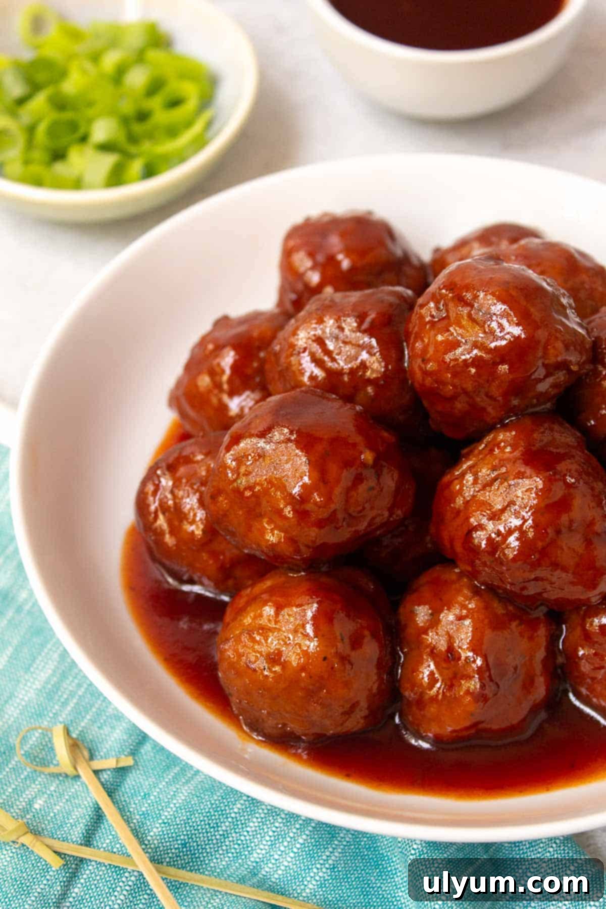 Instant Pot Grape Jelly Meatballs, garnished with fresh green onions and ready to serve.