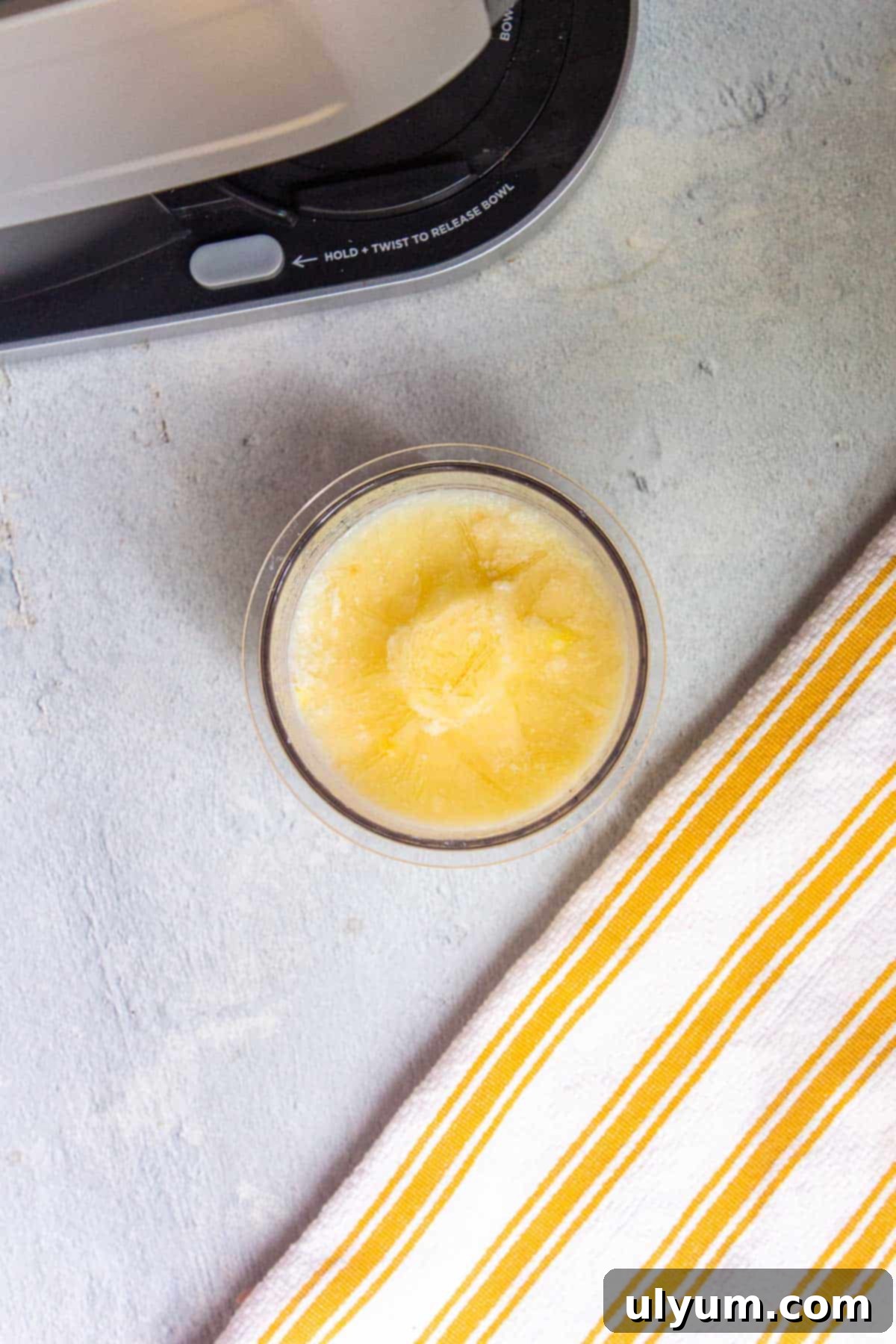 Frozen Ninja Creami Vanilla Protein Ice Cream mixture in a pint, ready for processing.