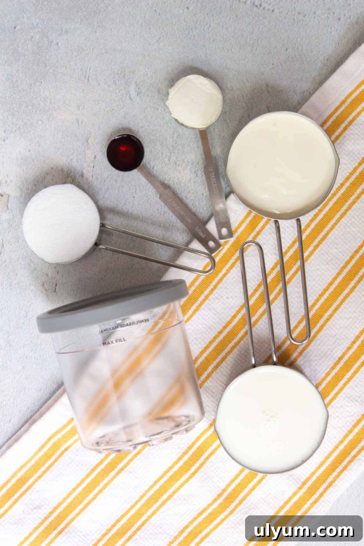 All 5 simple ingredients for Ninja Creami Vanilla Ice Cream: cream cheese, sugar, vanilla extract, whole milk, heavy cream
