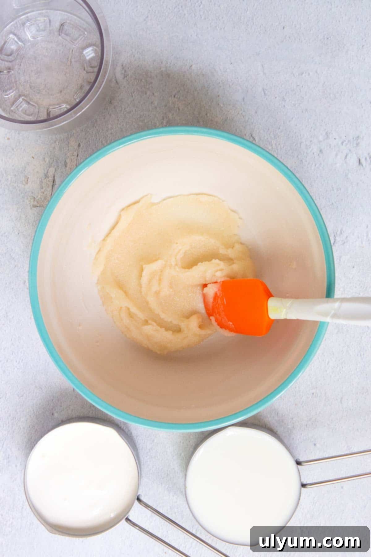 The vanilla and sugar are stirred into the cream cheese to create a thick paste