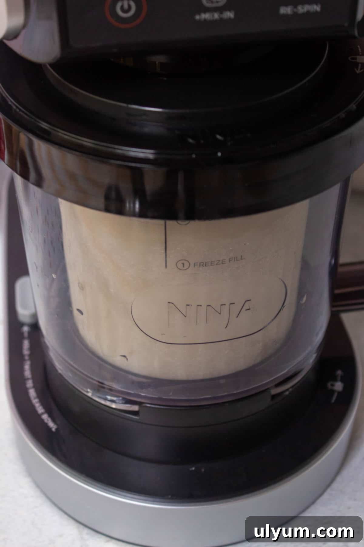 A pint is in the bowl assembly and inserted into the Ninja Creami motor base.