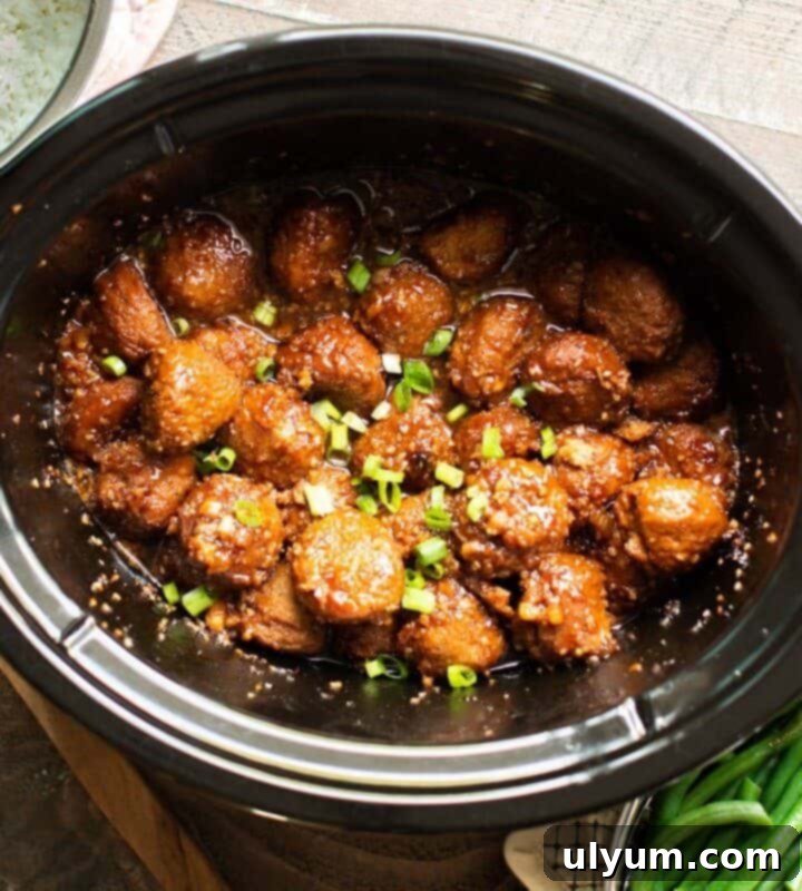 Effortless Frozen Meatball Meals 17 Ways 13 Slow Cooker Teriyaki Meatballs served with sesame seeds.