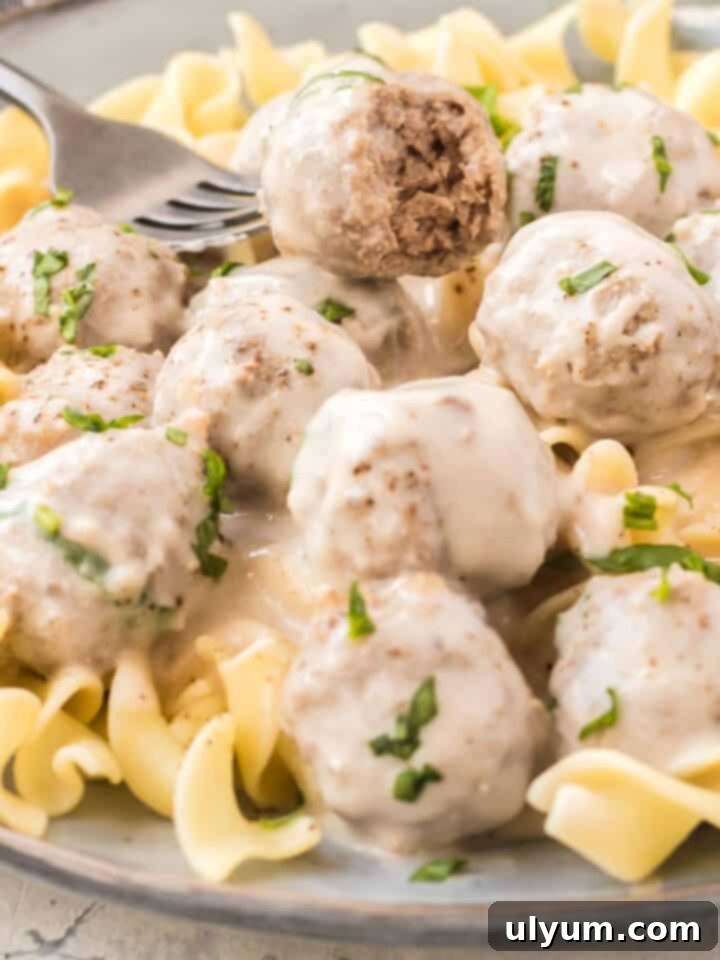 Effortless Frozen Meatball Meals 17 Ways 15 Fork in a Creamy Garlic Mushroom Meatball, showing its texture.