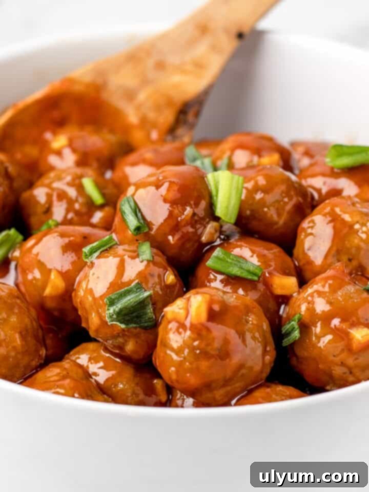 Effortless Frozen Meatball Meals 17 Ways 16 Honey Sriracha Meatballs garnished with cilantro and sesame seeds.