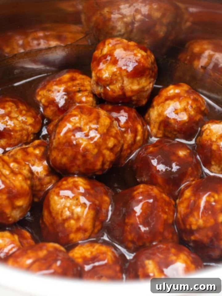 Effortless Frozen Meatball Meals 17 Ways 4 BBQ meatballs coated in sauce in an Instant Pot.