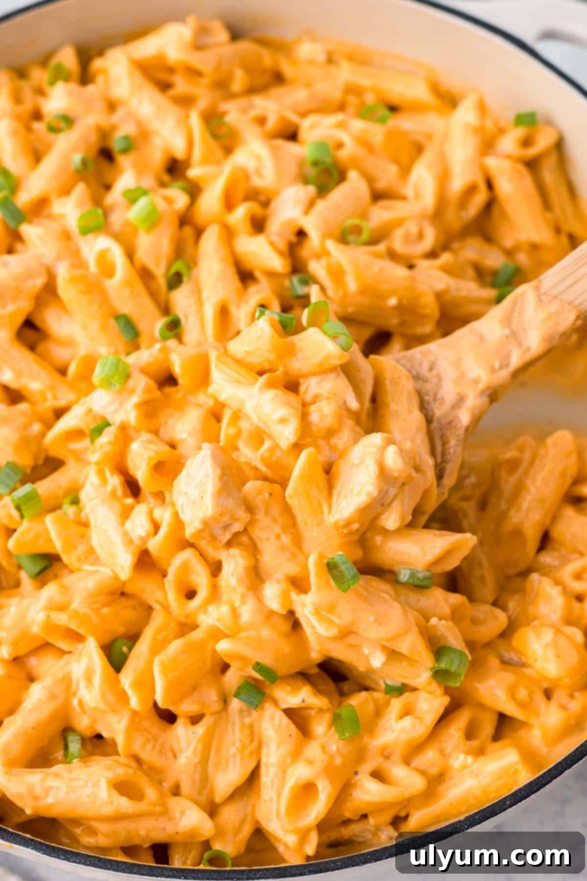 One-Pot Buffalo Chicken Mac and Cheese 12 Buffalo Chicken Pasta garnished with green onions and crumbled blue cheese, ready to serve