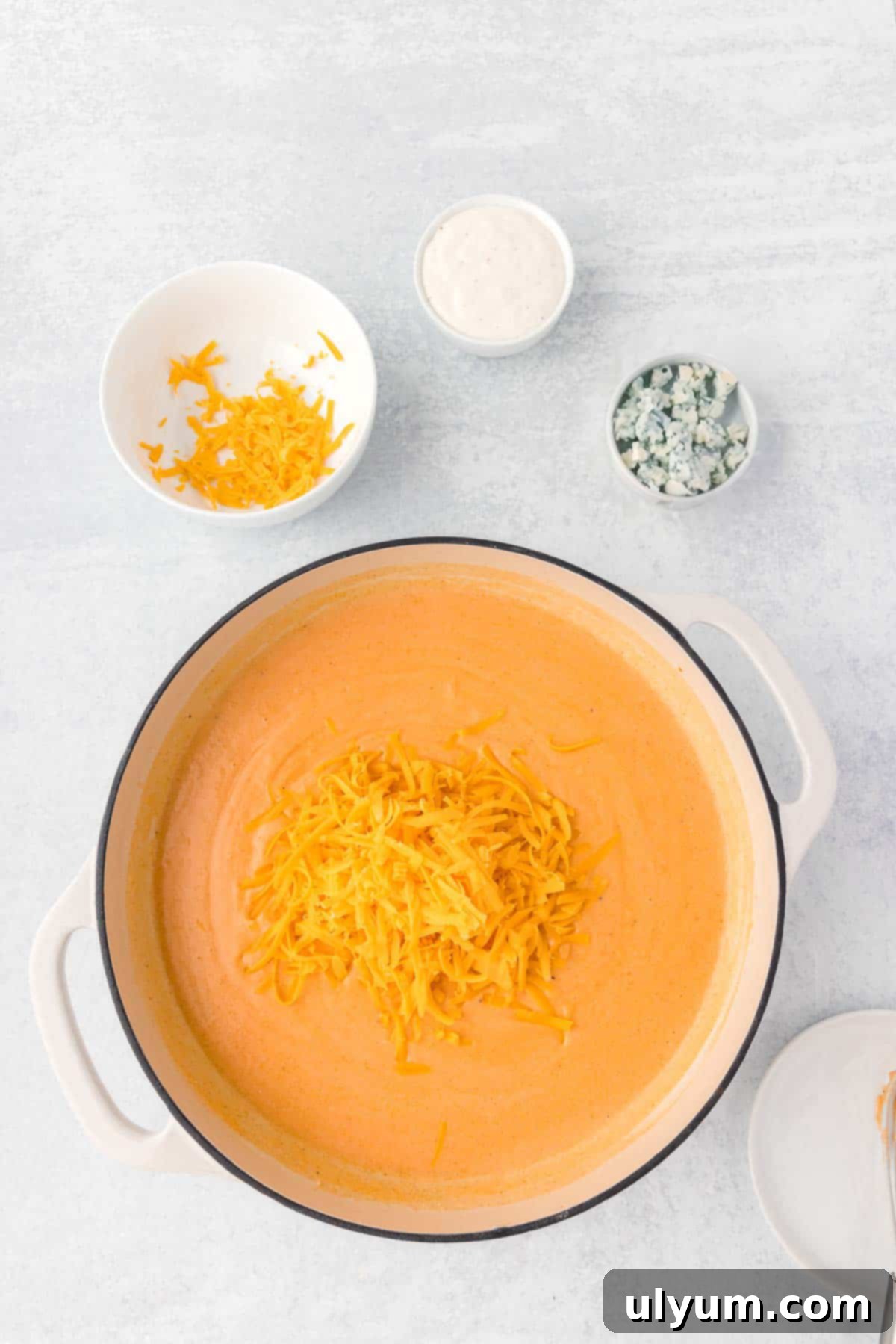 One-Pot Buffalo Chicken Mac and Cheese 7 Shredded cheddar is added to the hot sauce roux, melting into a creamy cheese sauce