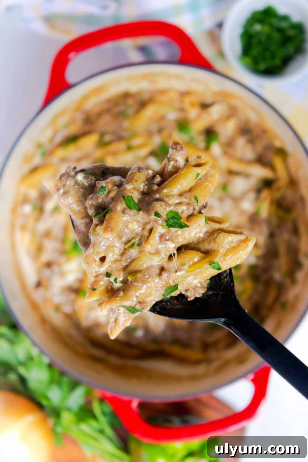 The cheese is melted and stirred into the pasta