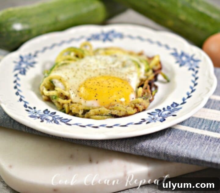 Individual Zucchini Egg Nests with a perfectly runny yolk, ideal for a low-carb and keto-friendly breakfast.