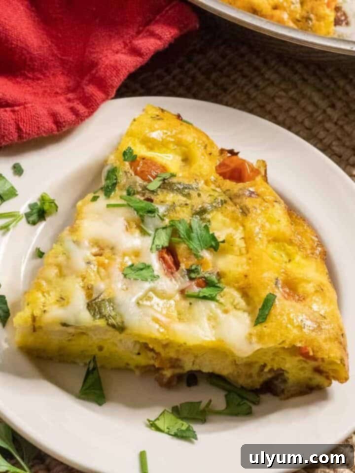 An Easy Loaded Frittata, perfect for any meal, with fresh vegetables, savory pancetta, and creamy cheese.