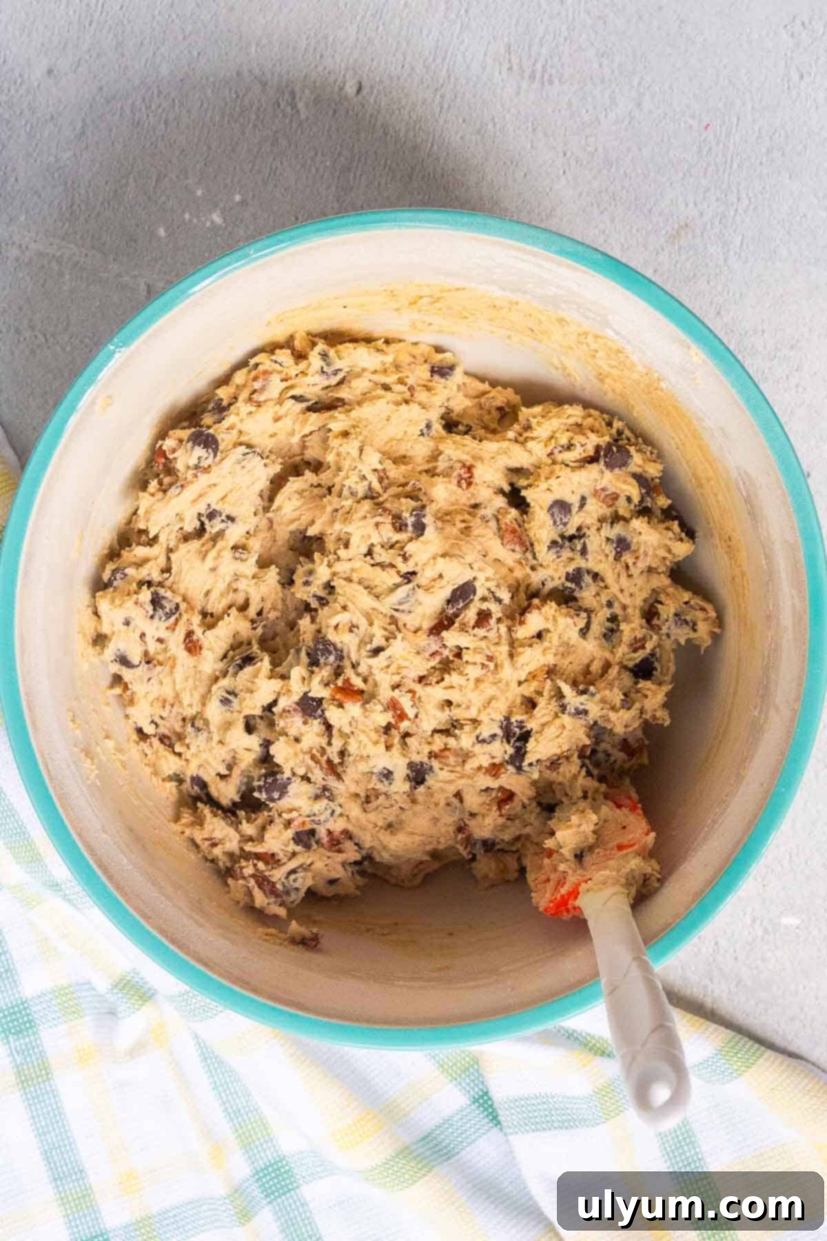 The pecans and chocolate chips are mixed in by hand until evenly distributed