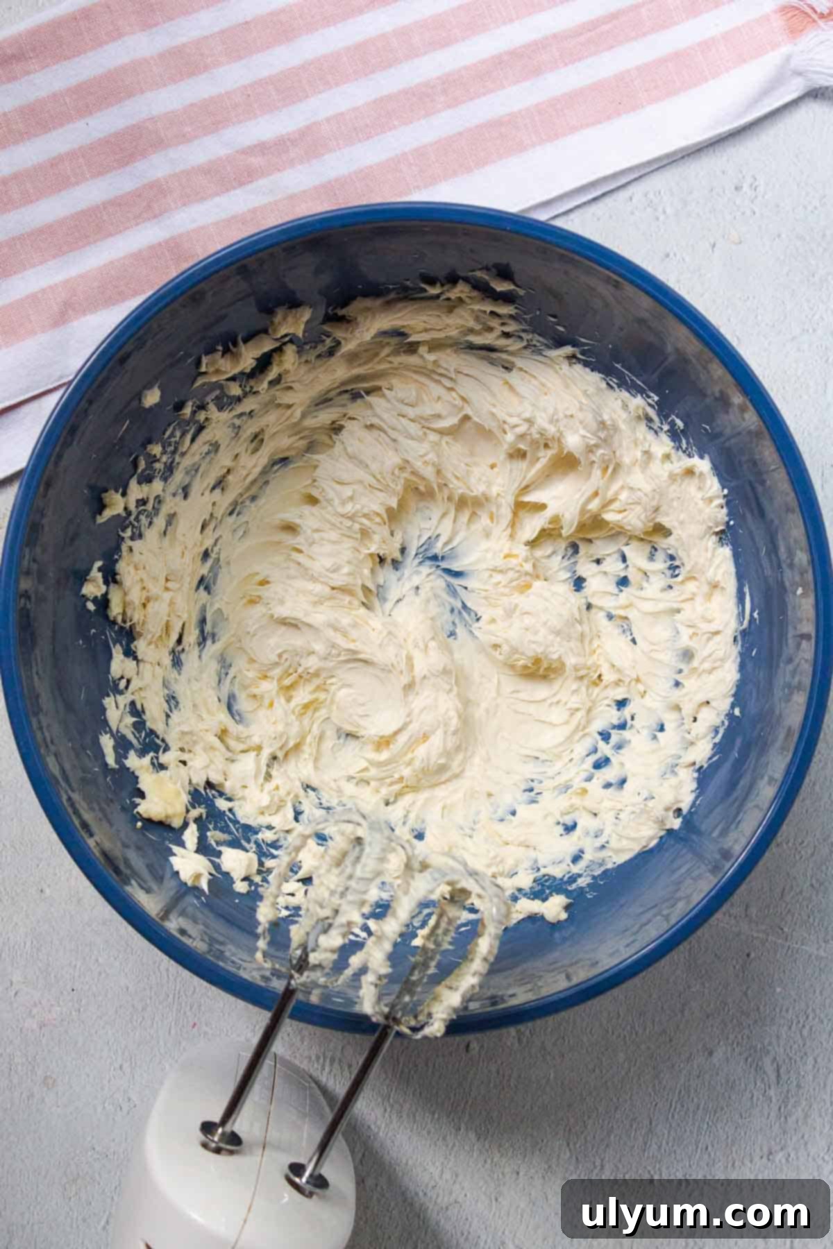 Cool Whip Cream Cheese Frosting 5 The softened cream cheese, softened butter, and vanilla are beaten together with a hand mixer in a large mixing bowl until light and fluffy, creating the creamy base for the Cool Whip frosting.